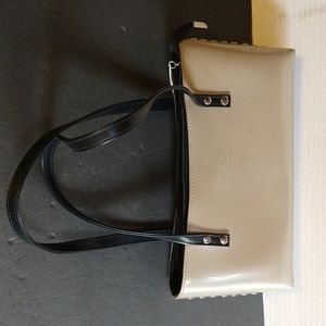 Beijo a pearlized gold color with black straps and trim.